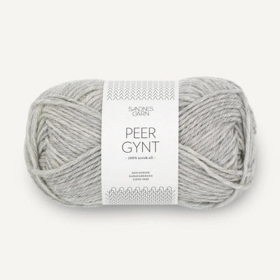 Ball of light grey yarn with a label on a white background