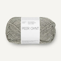 Ball of grey heathered yarn with a label on a white background