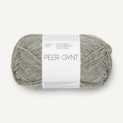 Ball of grey heathered yarn with a label on a white background