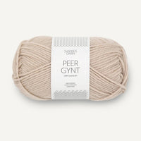 Ball of beige yarn with a label on a white background