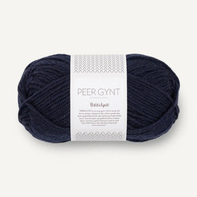 Navy blue ball of yarn with a label on a white background