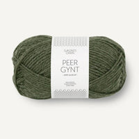 Ball of green yarn with a label on a white background