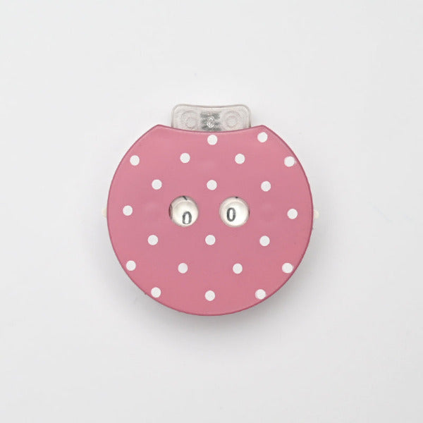 Pink polka dot row counter on a light gray background