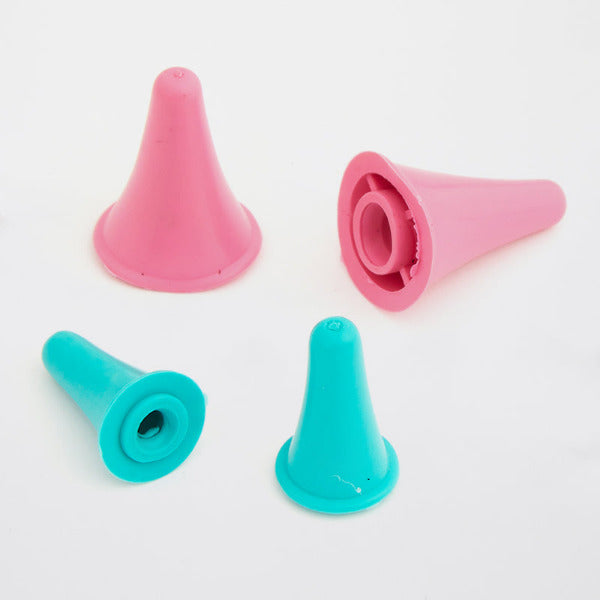 Two pink and two teal plastic cone-shaped point protectors on a white background