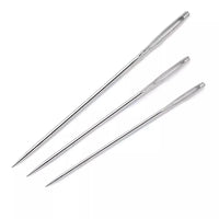 Three sharp metal embroidery needles on a white background