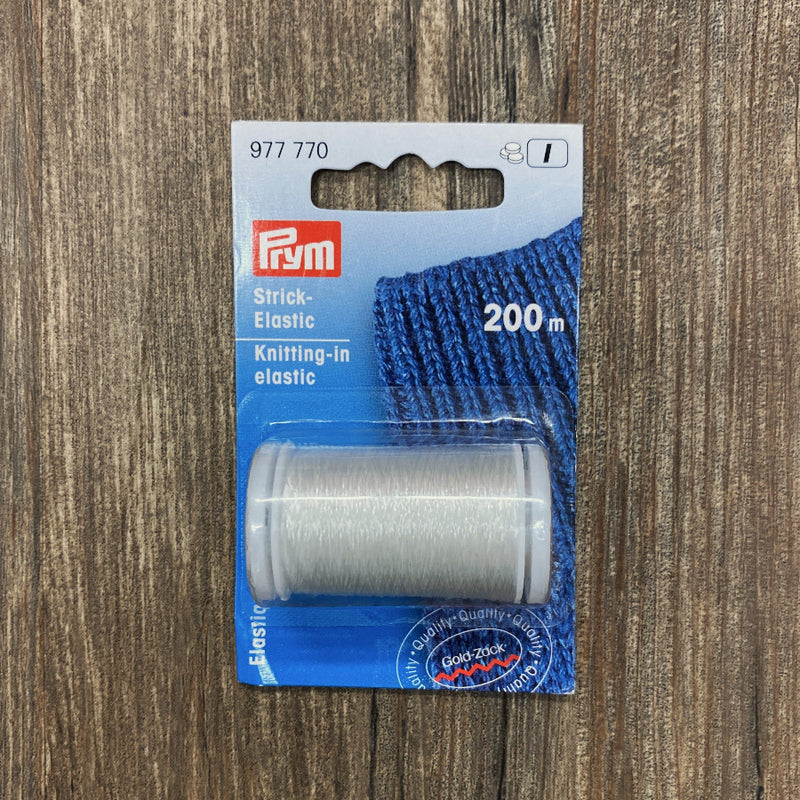 Packaged knitting elastic with Prym branding on a wooden surface