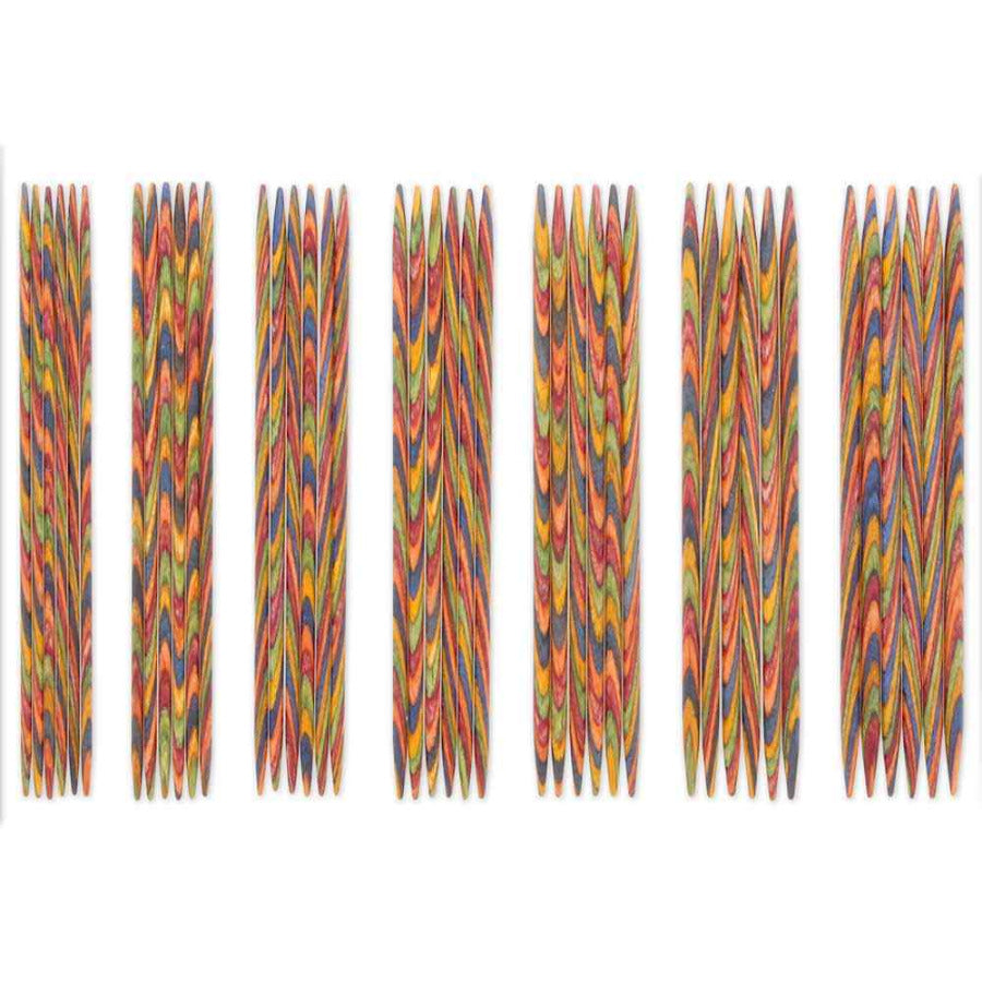Set of colorful knitting needles on a white background