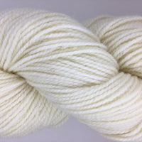 Close-up of cream-colored yarn on a light gray background