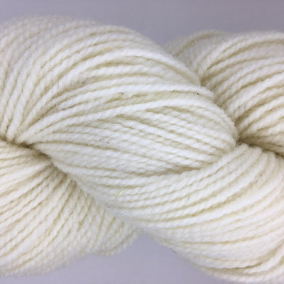 Close-up of cream-colored yarn on a light gray background