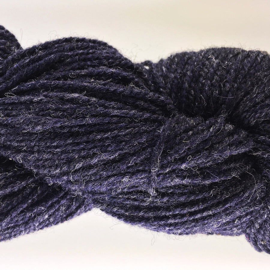 Close-up of very dark blue yarn on a white background