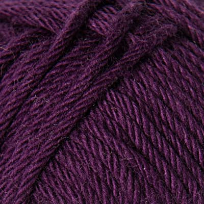 Close-up of a ball of burgundy purple yarn