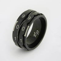 Black metal finger ring with numbers on it, on a white background