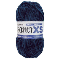 Navy blue chenille yarn ball with a label on a white background