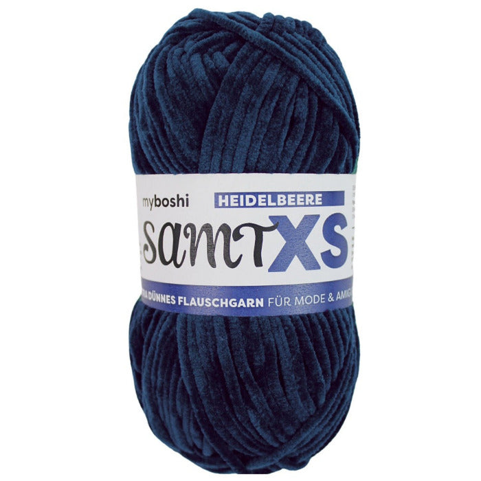 Navy blue chenille yarn ball with a label on a white background