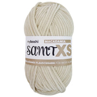 pale beige chenille yarn ball with a label on a white background