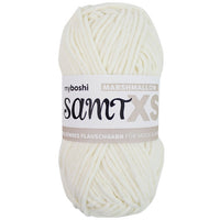 White chenille yarn ball with a label on a white background