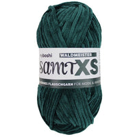 Green chenille yarn ball with a label on a white background
