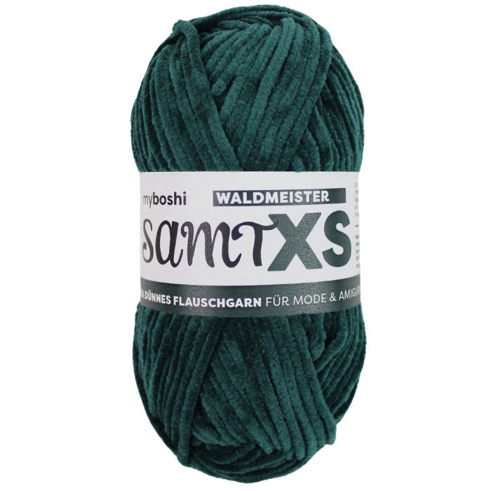 Green chenille yarn ball with a label on a white background