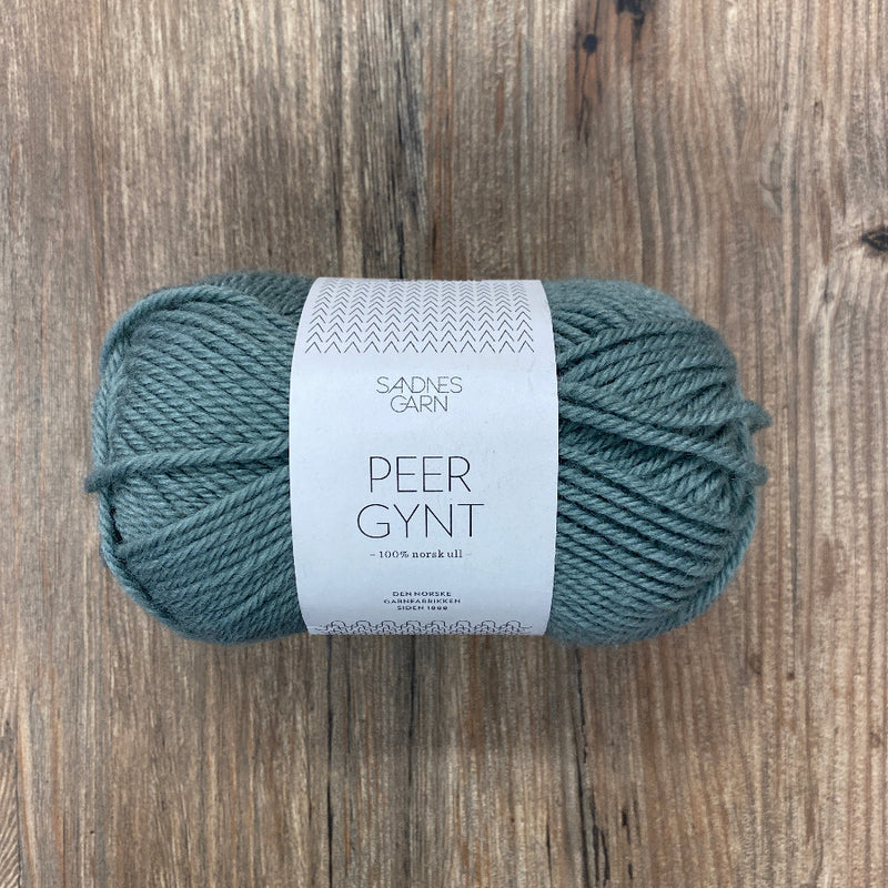 Ball of yarn with a label on a wooden surface