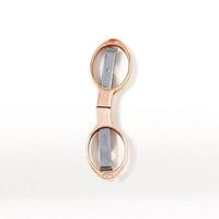 Rose gold folding scissors on a white background