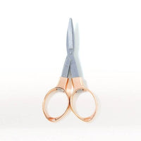 Rose gold-handled scissors on a white background