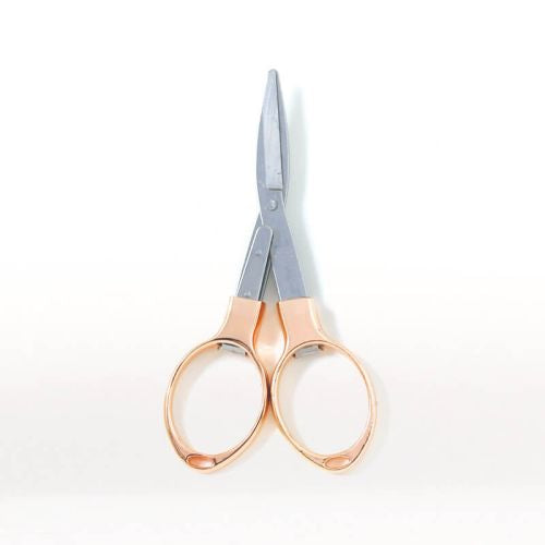 Rose gold-handled scissors on a white background