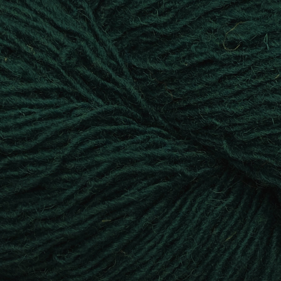 Close-up of a skein of dark emerald green yarn