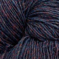 Close-up of a skein of dark purple, blue, and burgundy heathered yarn