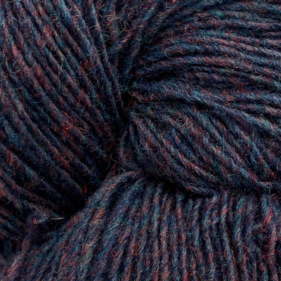 Close-up of a skein of dark purple, blue, and burgundy heathered yarn