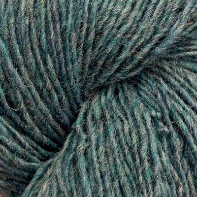 Close-up of a skein of grey and green heathered yarn