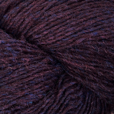 Close-up of a skein of dark burgundy and blue heathered yarn