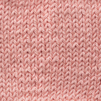Close-up of pale peach knitted fabric texture