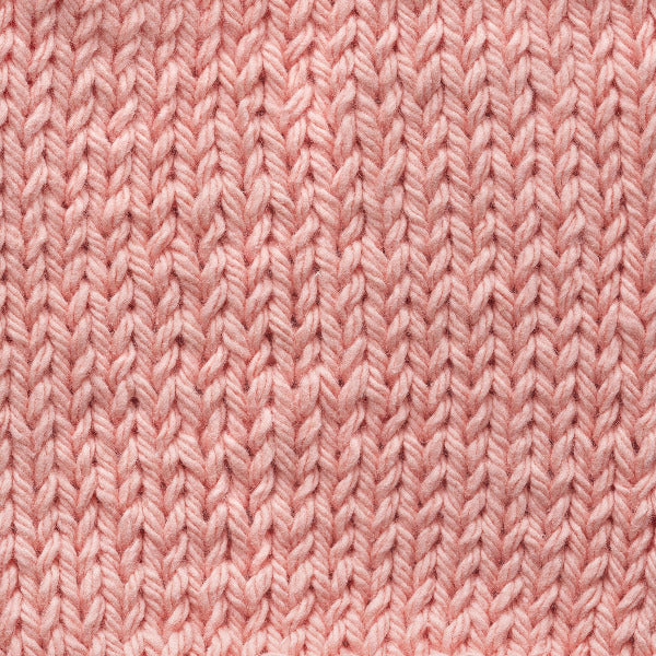 Close-up of pale peach knitted fabric texture