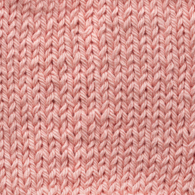 Close-up of pale peach knitted fabric texture