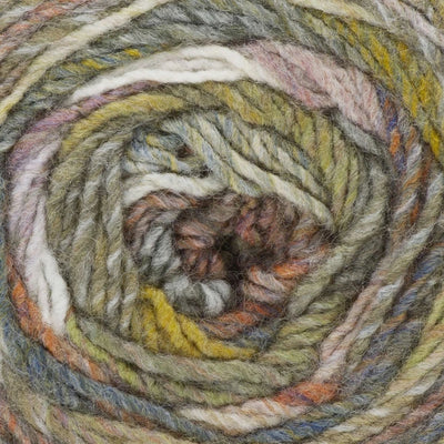 close up of multicoloured yarn in shades of tan, mustard, orange, purple, and blue