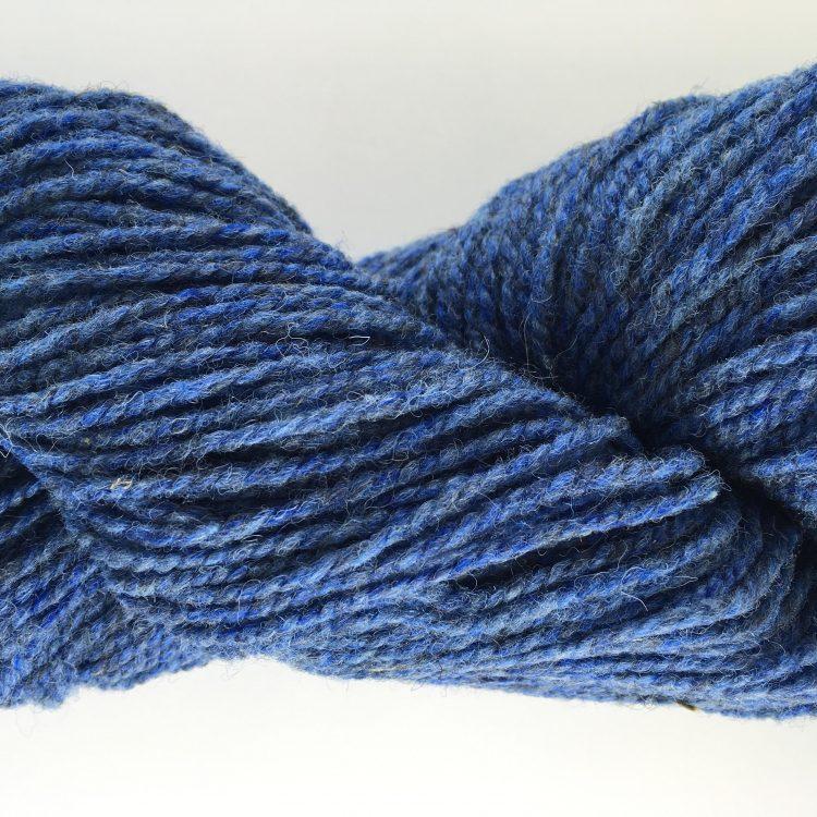 Close-up of blue yarn on a white background