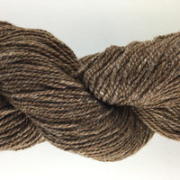 Close-up of brown yarn on a white background