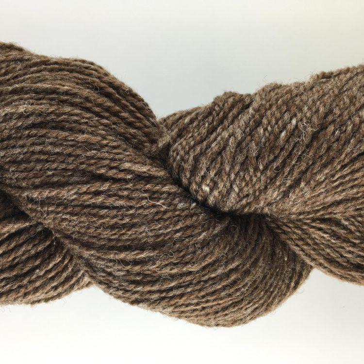 Close-up of brown yarn on a white background
