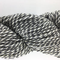 Close-up of gray and white yarn on a light gray background