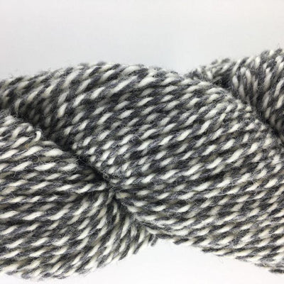 Close-up of gray and white yarn on a light gray background
