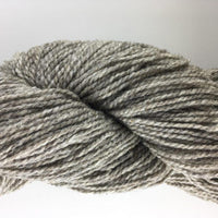 Close-up of pale brown heathered yarn on a white background