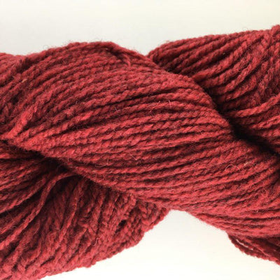 Close-up of a skein of red yarn on a white background