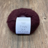 Ball of yarn with a label on a wooden surface