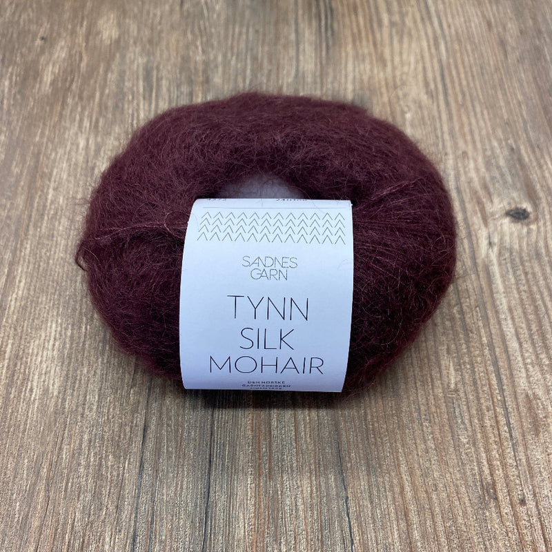 Ball of yarn with a label on a wooden surface