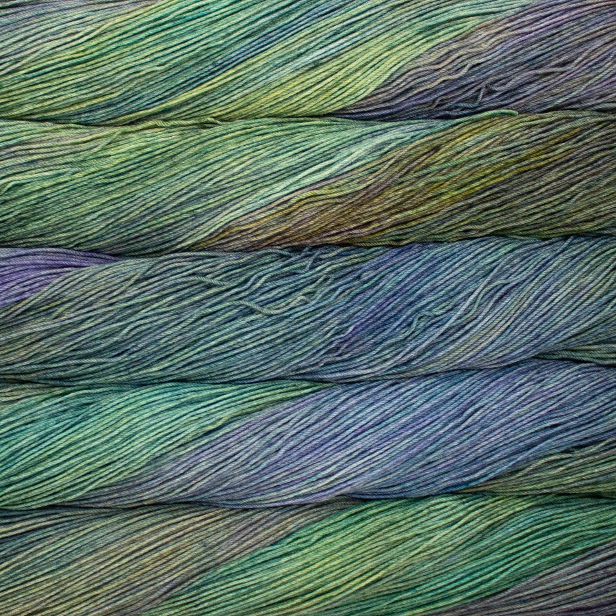 Close-up of multicolored yarn with shades of green, blue, and purple.