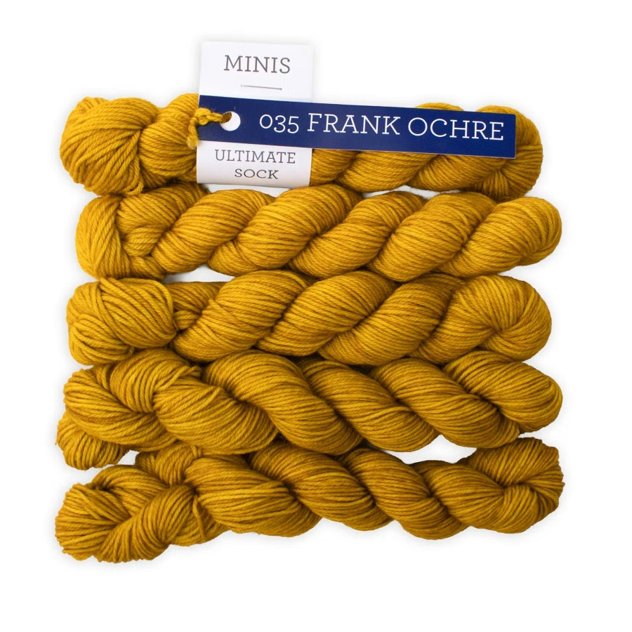 Yellow yarn skeins with a label on a white background