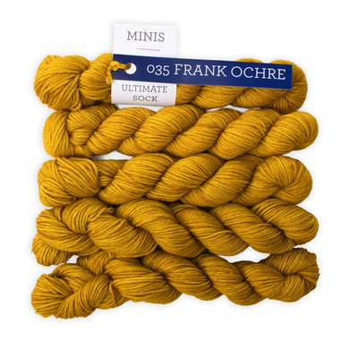 Yellow yarn skeins with a label on a white background