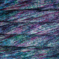 Close-up of multicolored yarn skeins in heavy blue and purple speckles