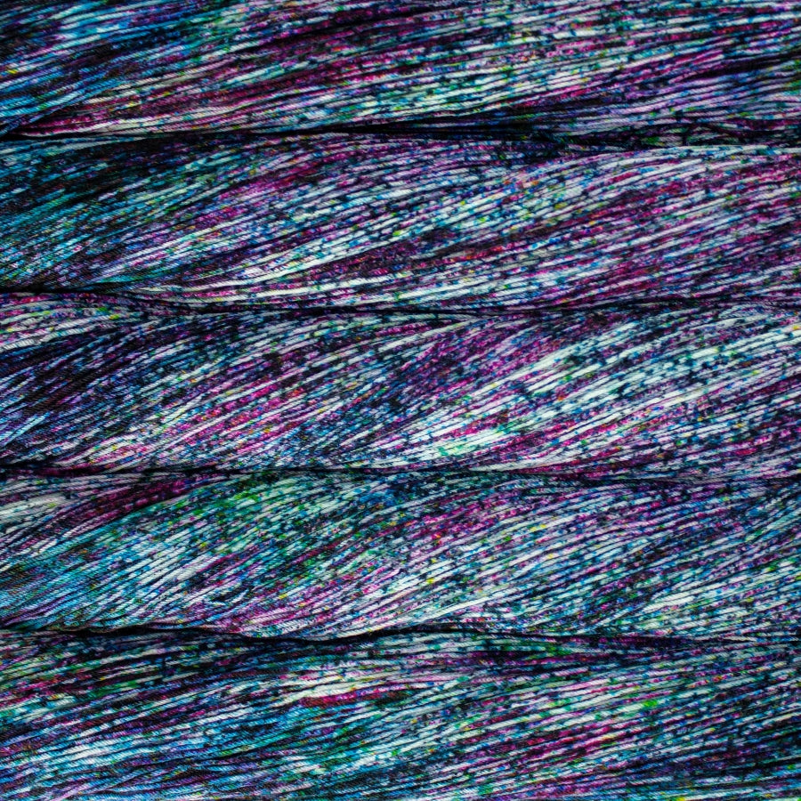 Close-up of multicolored yarn skeins in heavy blue and purple speckles