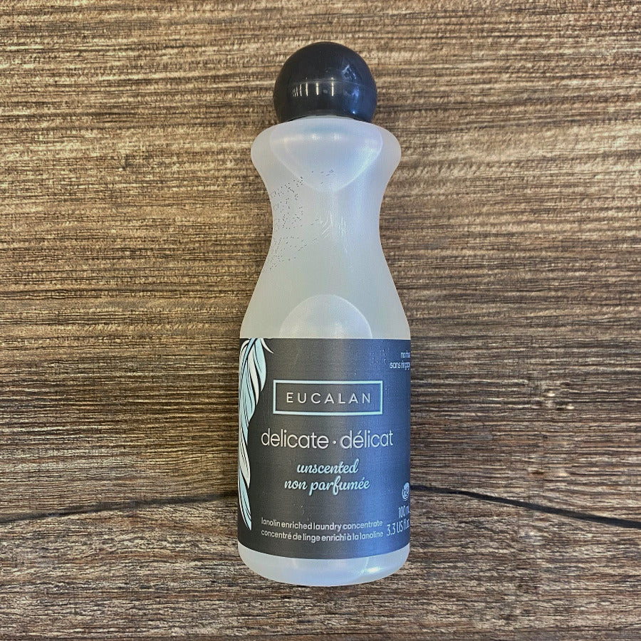 Bottle of Eucalan delicate detergent on a wooden surface